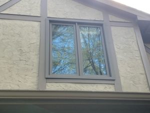 Replacement sliding windows on a modern Tudor home.