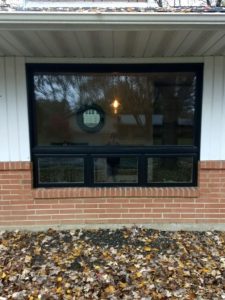 A large replacement window on a suburban home.