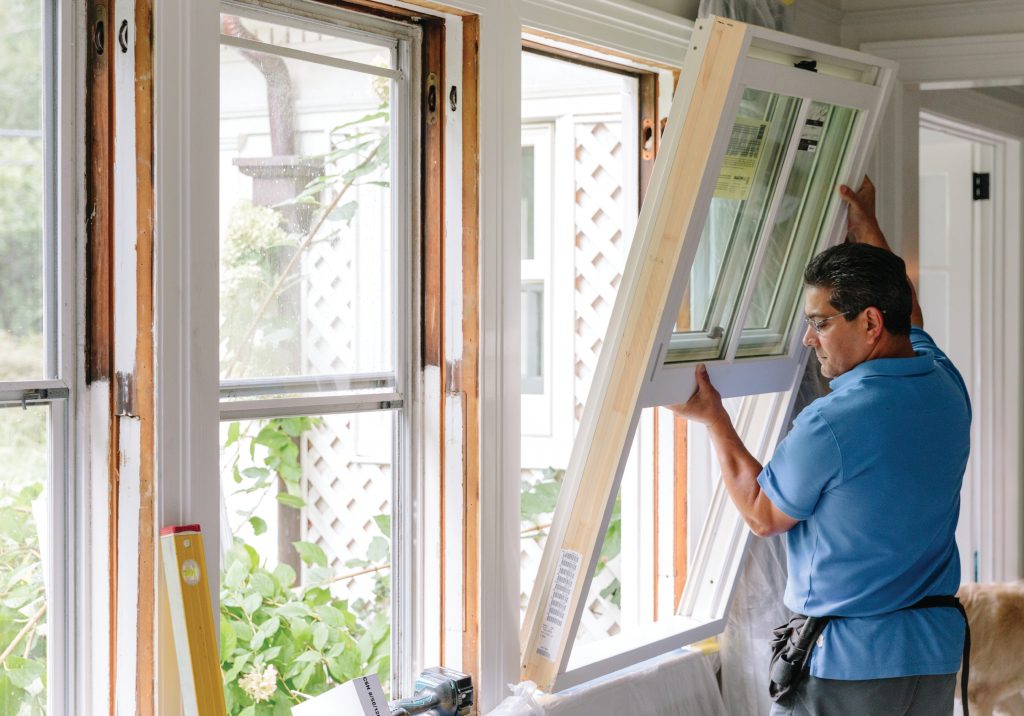 Man installing a replacement window 